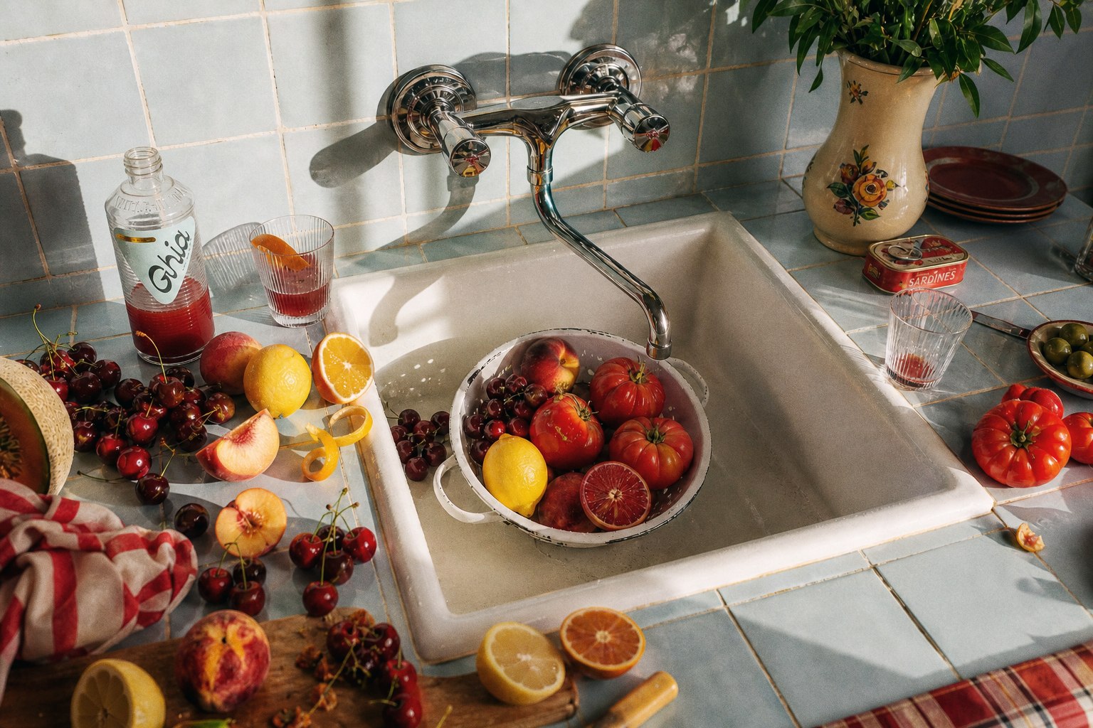 Sunlit tiny kitchen sink with fruit and Ghia