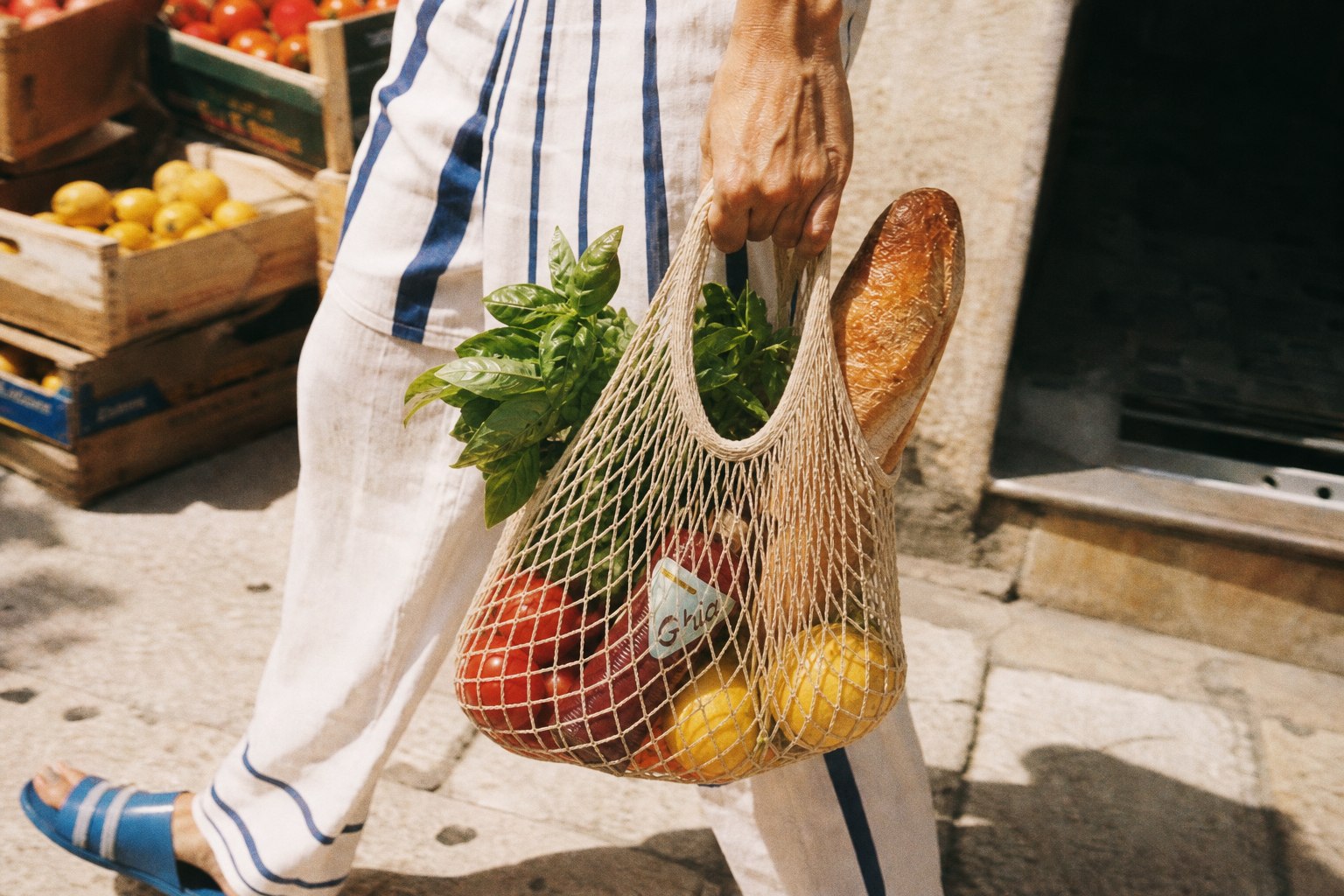 Net market bag with produce, bread, and Ghia