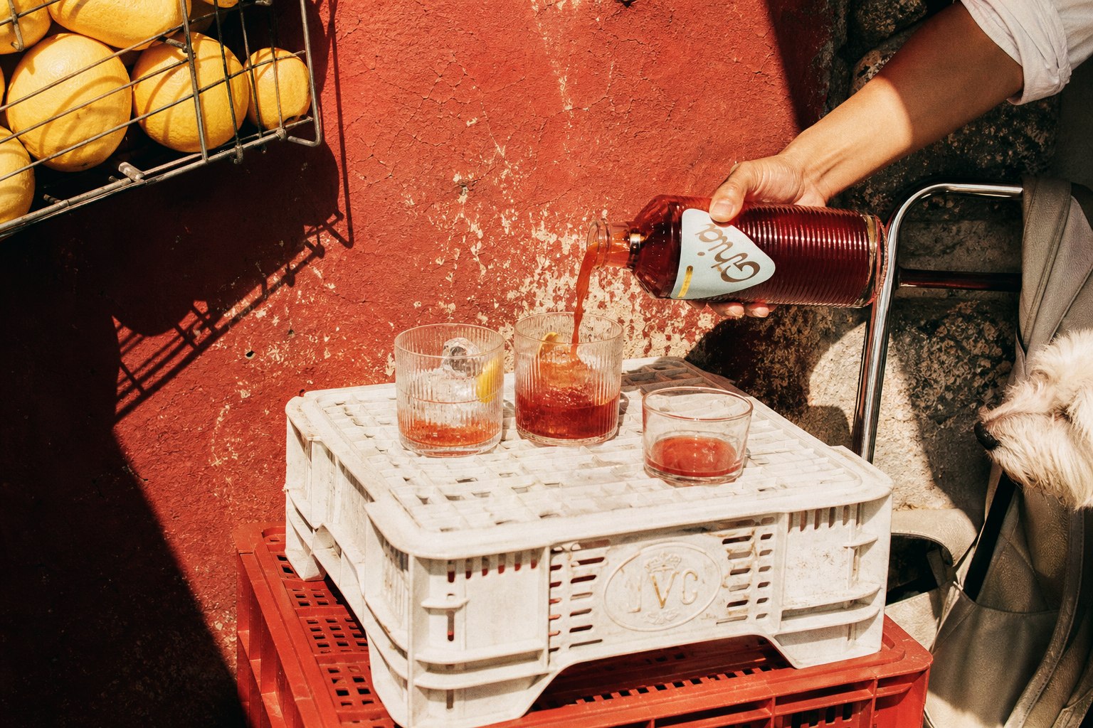 Ghia poured into glasses on stacked market crates