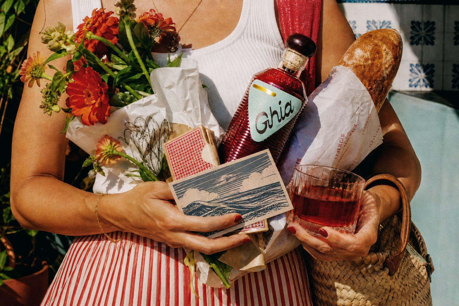 Dinner guest carrying Ghia, flowers, cards, and bread